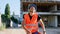 Good looking young worker at construction site with a safety equipment dancing at the break time he listening music from