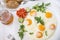 Good loooking tasty breakfast- fried eggs decorated with green parsley, mint, tomato, cucumber