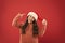 Good mood. Winter traditions. Adorable girl with long curly hair wear santa claus hat red background. Counting days till