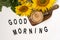 Good Morning. A bouquet of large sunflowers and hot coffee. Sunflower arrangement flat lay style on background white