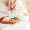 Good morning concept. Breakfast in bed with Have a nice day text on lighted box, coffee and macaroons on tray and woman in