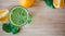 Good morning: Fresh green smoothie and fruits on wooden background, healthy breakfast. Text space