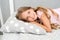 Good morning. Girl child long hair lay awake close up. Quality of sleep depends on many factors. Choose proper pillow to