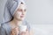 Good morning and skin care concept - close up portrait of woman with facial mask drinking coffee