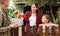 Good neighbors communicate while standing by fence between houses