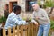 Good neighbors talk on the border of their farms