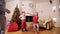 Good New Year spirit: Christmas tree, gift bag, fireplace - kids play the fool, they are cozy and homey waiting for Santa.