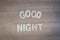 Good Night words with wood letters over wood background