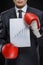 Good results. Confident businessman in red boxing gloves holding