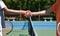 Good sportsmanship. a two young tennis players shaking hands over the net.