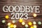 Goodbye 2023 alphabet letter with cotton ball LED decoration on wooden background