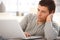 Goodlooking man focusing on laptop