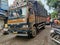 Goods carrying brown color heavy truck moving forward on asphalt road at busy wholesale market area in Gandhinagar Kolhapur