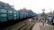 Goods train freight train or a cargo train of Indian Railway running on the railway track and passing an indian railway station