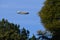 Goodyear blimp amid trees and blue skies