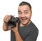 Goofy Hispanic Young Male With DSLR Camera Isolated on a White B