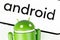 Google Android figure and smartphone displayed text Android