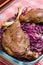 Goose legs baked on red cabbage