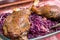 Goose legs baked on red cabbage