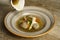 Goose soup, consomme with dumplings and vegetables