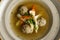Goose soup, consomme with dumplings and vegetables