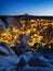 Goreme, Cappadocia, Turkey. View of the evening city from the mountain. Bright evening city and clear sky. Landscape in the summer