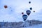 Goreme, Turkey - December 31, 2019: Tourists riding the colorful hot air balloon which it is flying over Goreme, Cappadocia