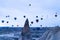 Goreme, Turkey - December 31, 2019: Tourists riding the colorful hot air balloon which it is flying over Goreme, Cappadocia lands