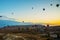 Goreme, Turkey. Numerous hot air balloons all lift into the air just after dawn