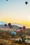 Goreme, Turkey. Numerous hot air balloons all lift into the air just after dawn