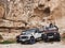 Goreme, Turkey - October 2019. Three Land Rover offroad cars park in front of typical cappadocian cave house remains