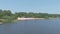 Gorgeous aerial footage of the rippling silky green waters of Lake Acworth with people relaxing on the sandy beach
