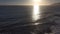 Gorgeous aerial footage of the vast blue ocean water with majestic waves rolling into the beach at sunset at Marina Park Beach