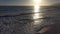 Gorgeous aerial footage of the vast blue ocean water with majestic waves rolling into the beach at sunset at Marina Park Beach