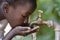 Gorgeous African Black Girl Drinking with Hands Cupped Drought