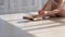 Gorgeous ballet dancer in tutu sitting on the floor and tying pointe shoes