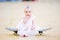 Gorgeous barefoot baby girl on skateboard