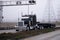 Gorgeous black big rig semi truck flat bed trailer devided road