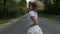 Gorgeous blonde attractive woman running on a forest road and smiling -