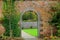 Gorgeous brick and stone archways through garden
