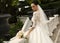 Gorgeous bride with dark hair wears elegant wedding dress