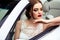 Gorgeous bride with fashion makeup and hairstyle near luxury wedding dress near white cabriolet car