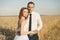 Gorgeous bride and groom in wheat field. Happiness and marriage