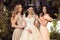 Gorgeous bride in luxurious wedding dress, posing with beautiful bridesmaids in elegant dresses