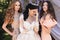 Gorgeous bride in luxurious wedding dress, posing with beautiful bridesmaids in elegant dresses