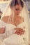 Gorgeous bride in luxurious wedding dress and veil