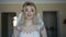 Gorgeous bride smiles and easy poses at camera indoors 4K