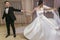 Gorgeous bride and stylish groom emotionally dancing at wedding reception in restaurant. happy newlywed couple performing first