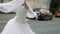 gorgeous bride in white dress is whirling in street of city, happy woman in wedding day