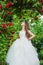 Gorgeous bridesmaid fashionable girl white dress roses garden, holidays concept